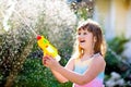 Kids with water gun toy in garden. Outdoor fun Royalty Free Stock Photo