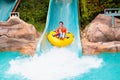 Kids on water slide. Family in aqua theme park Royalty Free Stock Photo