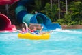 Kids on water slide. Family in aqua theme park Royalty Free Stock Photo