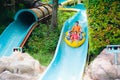 Kids on water slide. Family in aqua theme park Royalty Free Stock Photo