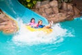 Kids on water slide. Family in aqua theme park Royalty Free Stock Photo