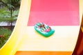 Kids on water slide. Family in aqua theme park Royalty Free Stock Photo