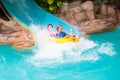 Kids on water slide. Family in aqua theme park Royalty Free Stock Photo