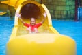 Kids on water slide. Family in aqua theme park Royalty Free Stock Photo