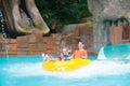 Kids on water slide. Family in aqua theme park Royalty Free Stock Photo