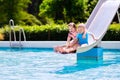 Kids on water slide in swimming pool Royalty Free Stock Photo