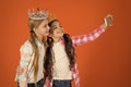 Kids wear golden crowns symbol princess. Warning signs of spoiled child. Avoid raising spoiled kids. Girls taking selfie