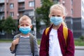 Kids wearing mask and backpacks protect and safety from coronavirus for back to school. Brother and sister going school Royalty Free Stock Photo