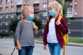 Kids wearing mask and backpacks protect and safety from coronavirus for back to school. Brother and sister going school Royalty Free Stock Photo