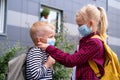 Kids wearing mask and backpacks protect and safety from coronavirus for back to school. Brother and sister going school Royalty Free Stock Photo