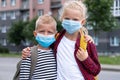 Kids wearing mask and backpacks protect and safety from coronavirus for back to school. Brother and sister going school Royalty Free Stock Photo