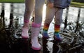 Kids wearing striped wellingtons in the puddle Royalty Free Stock Photo