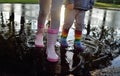 Kids wearing wellingtons in the puddle Royalty Free Stock Photo