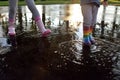 Kids wearing wellingtons in the puddle Royalty Free Stock Photo