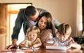 Kids were born to be creative. a young family of four drawing and getting creative together at home. Royalty Free Stock Photo