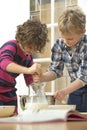 Kids whisking batter Royalty Free Stock Photo