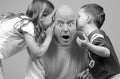 Kids Whispering to Dad Royalty Free Stock Photo