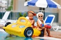 Kids whit infatable toys in pool Royalty Free Stock Photo