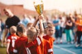 Kids Winning Sports Competition. Children Soccer Team with Trophy. Boys Celebrating Football Championship in Primary School Royalty Free Stock Photo