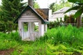 Kids wood play house in the grass. Home backyard.