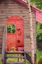 Kids wooden tree house with pink roof in summer forest