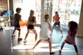 Kids working out using resistance band in gym together with female trainer. Sport, healthy lifestyle, physical education