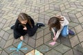 Kids young girls drawing with colorful chalks outdoor. Outside leisure activities for children concept Royalty Free Stock Photo