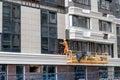 Worker assembles a ventilated facade on a residential building under construction in Kyiv