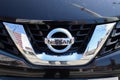 Closeup of the Nissan logo on a new car front