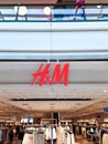 Kiel, Germany - 01. April 2024: A large red H and M logo of the Hennes and Mauritz brand above the entrance to a store