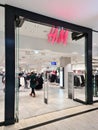 Kiel, Germany - 30 December 2023: H and M logo above the entrance to a store