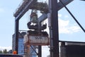 Kiel, Germany - 27.December 2022: A large industrial crane lifts heavy containers with cargo at the port of Kiel in sunny weather