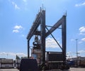 Kiel, Germany - 27.December 2022: A large industrial crane lifts heavy containers with cargo at the port of Kiel in sunny weather
