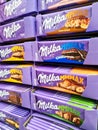 Kiel, Germany - 12 December 2023: Numerous varieties of Milka brand chocolate on a supermarket shelf