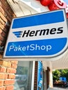 Kiel, Germany - 13. July 2023: Company sign of the parcel service Hermes in front of a shop