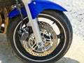 Front wheel of a blue Honda bike