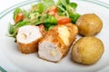 Kiev cutlet with jacket potatoes and salad Royalty Free Stock Photo