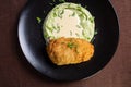 Kiev cutlet with mashed potatoes on a black plate Royalty Free Stock Photo