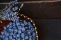 Fresh blueberries on a wooden board, dark background. Lavender. Vertical photo.