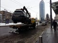 Kiev, March 6, 2018, Ukraine. Traffic police officers on street to pick up intruder`s car on tow truck. Loading tow truck car of Royalty Free Stock Photo