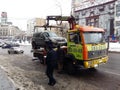 Kiev, March 6, 2018, Ukraine. Traffic police officers on street to pick up intruder`s car on tow truck. Loading tow truck car of Royalty Free Stock Photo