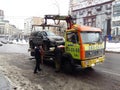 Kiev, March 6, 2018, Ukraine. Traffic police officers on street to pick up intruder`s car on tow truck. Loading tow truck car of Royalty Free Stock Photo