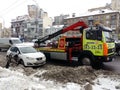 Kiev, March 6, 2018, Ukraine. Traffic police officers on street to pick up intruder`s car on tow truck. Loading tow truck car of Royalty Free Stock Photo