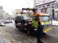 Kiev, March 6, 2018, Ukraine. Traffic police officers on street to pick up intruder`s car on tow truck. Loading tow truck car of Royalty Free Stock Photo