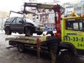 Kiev, March 6, 2018, Ukraine. Traffic police officers on street to pick up intruder`s car on tow truck. Loading tow truck car of Royalty Free Stock Photo