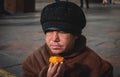 Kiev November 12: a homeless woman eats on the street