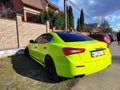 KIEV, UKRAINE - APRIL 09, 2021: bright green maseratti sports car parked on the street