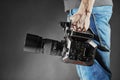 Kiev, Ukraine - April 22, 2018: Cameraman holds an movie camera Panasonic AU-EVA1 in studio