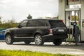 Kiev, Ukraine - April 21, 2020: Range Rover SUV at a fuel station. Petrol. Diesel. Masked man