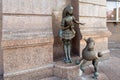 A sculpture of a blue-haired girl and her four-legged friend .